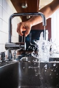 running faucet into cup