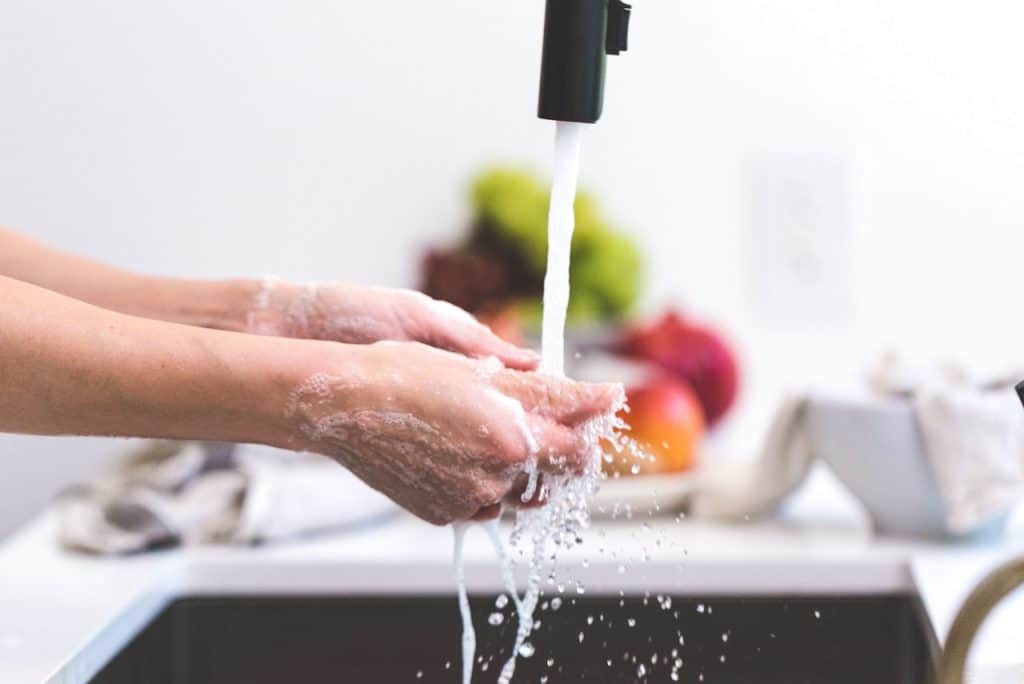 running faucet over hands